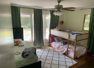 A sunny room with a twin bed and set of bunk beds.