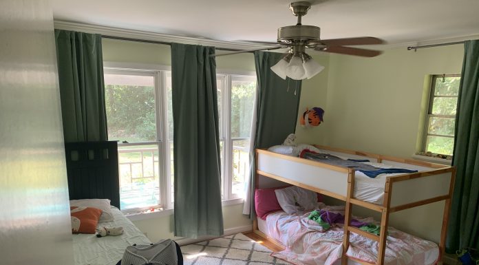 A sunny room with a twin bed and set of bunk beds.